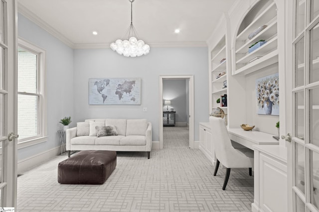 home office with baseboards, built in desk, a chandelier, and crown molding