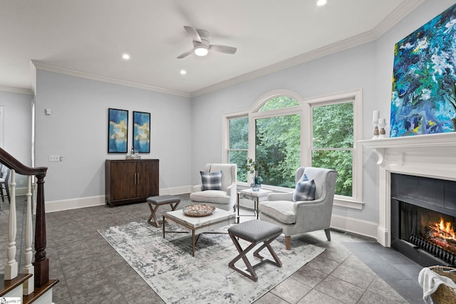 living room featuring a fireplace with flush hearth, baseboards, a ceiling fan, and a healthy amount of sunlight