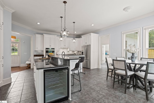 kitchen with beverage cooler, white cabinets, dark countertops, and stainless steel appliances