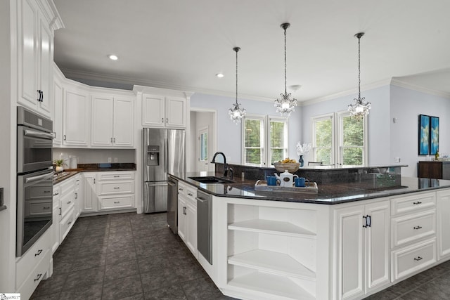 kitchen featuring a sink, open shelves, a chandelier, appliances with stainless steel finishes, and a kitchen island with sink