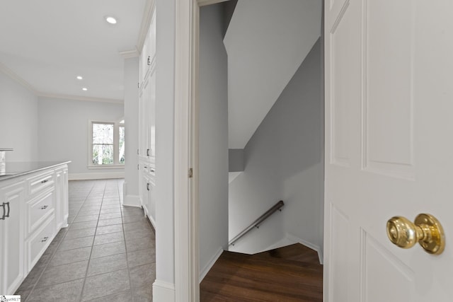 hall with light tile patterned flooring, an upstairs landing, recessed lighting, baseboards, and ornamental molding