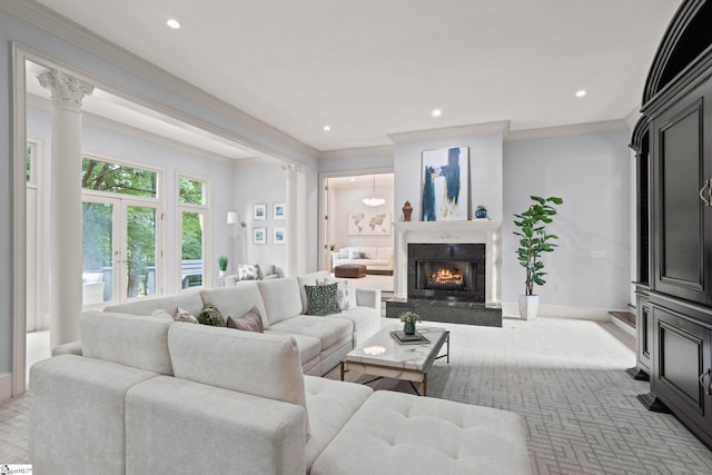 living room with decorative columns, crown molding, baseboards, and recessed lighting