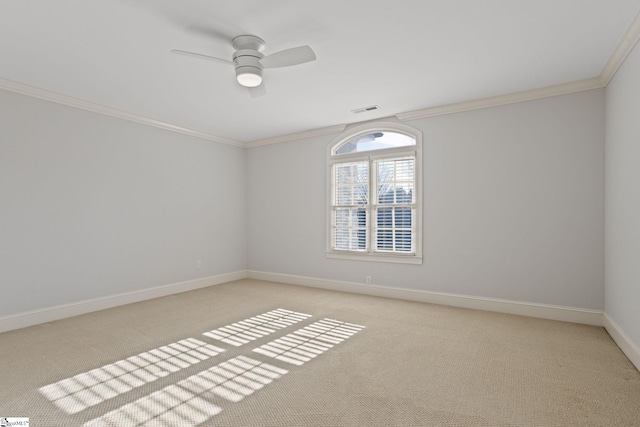 unfurnished room with visible vents, baseboards, ornamental molding, a ceiling fan, and carpet floors