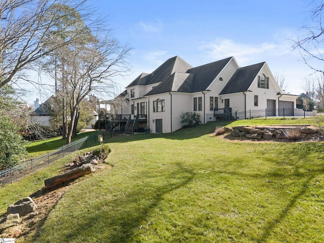 exterior space featuring a fenced backyard, stucco siding, a garage, and a yard