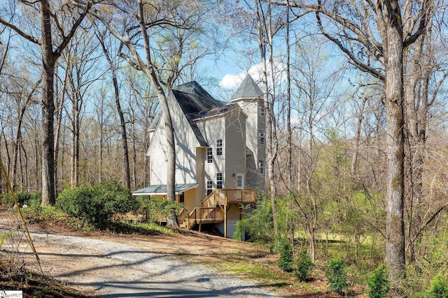 view of property exterior with a chimney and a wooden deck