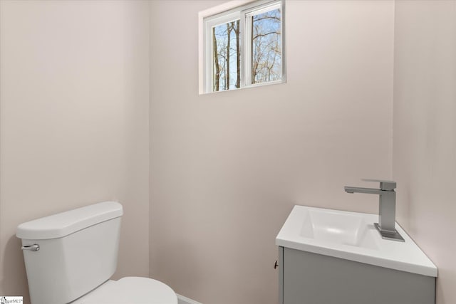 half bathroom featuring toilet and vanity