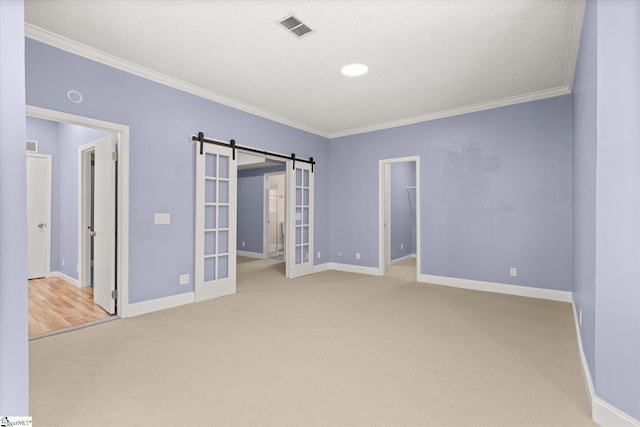 unfurnished room featuring baseboards, ornamental molding, and visible vents