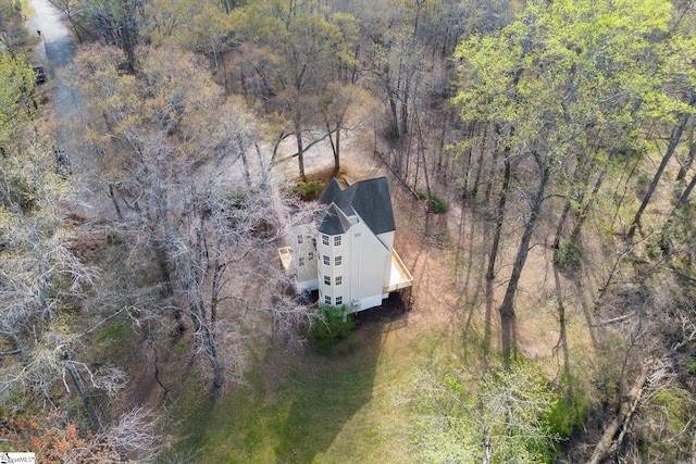 birds eye view of property with a forest view