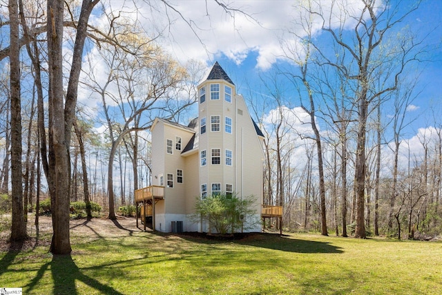view of property exterior featuring a wooden deck and a yard