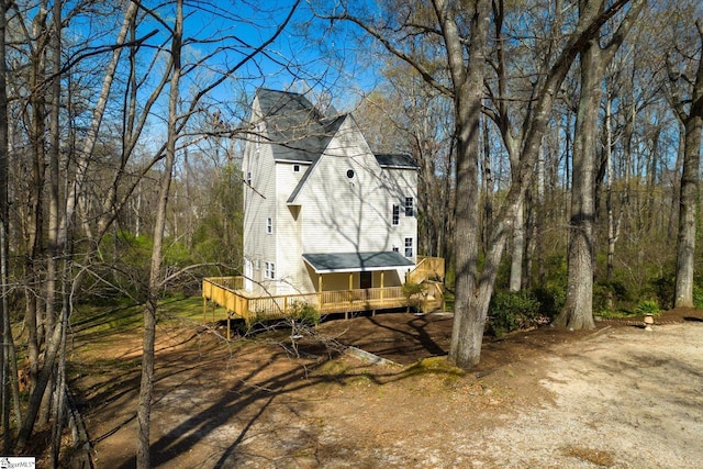 view of property exterior featuring a wooden deck