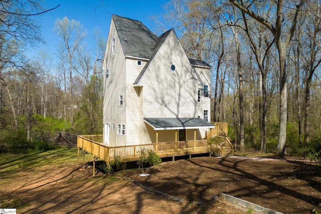 view of property exterior with a deck