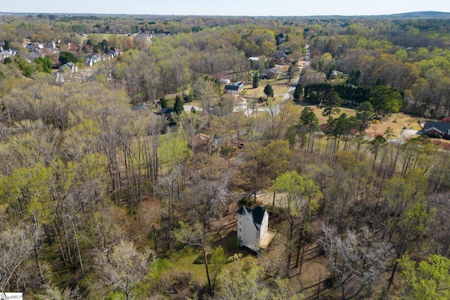 birds eye view of property with a wooded view