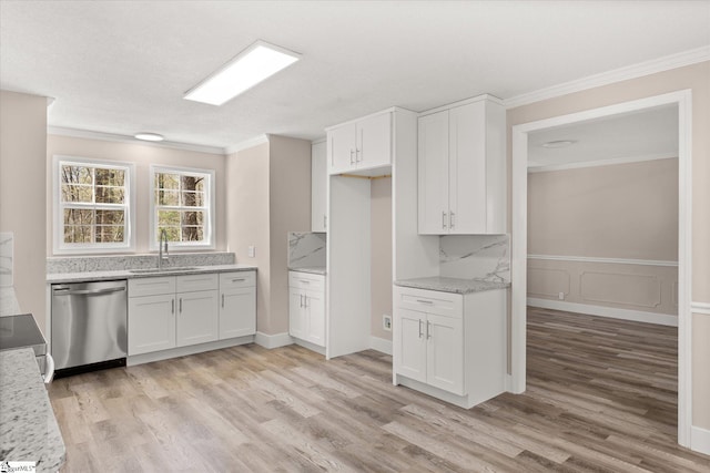 kitchen featuring white cabinets, a sink, ornamental molding, and dishwasher