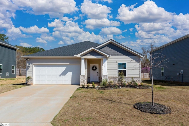 view of front of property with a front yard, driveway, and an attached garage