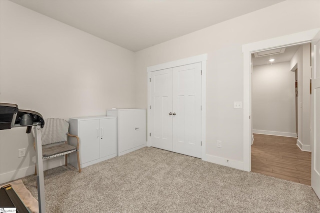 interior space with attic access, baseboards, and carpet floors