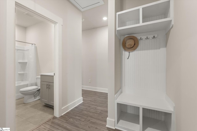 mudroom with baseboards and wood finished floors