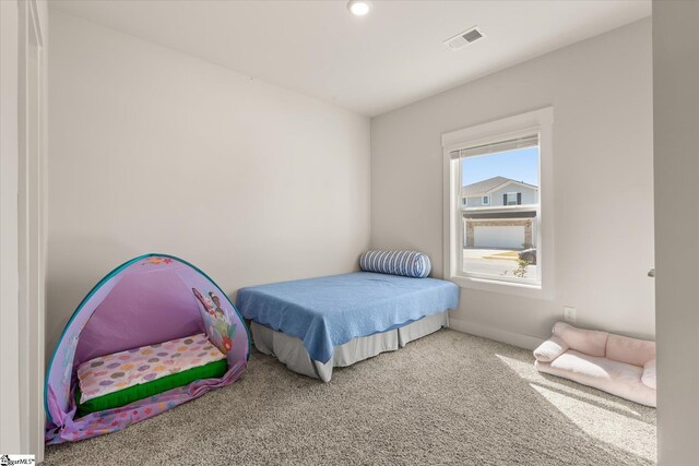 bedroom with baseboards, carpet floors, and visible vents