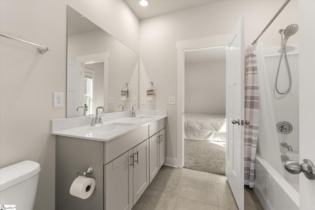full bath with shower / bath combo, double vanity, a sink, and toilet