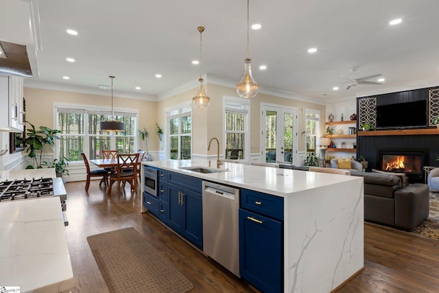 9 Graywood Ct, Simpsonville, SC 29680 - kitchen featuring blue cabinetry, crown molding, a sink, appliances with stainless steel finishes, and a fireplace
