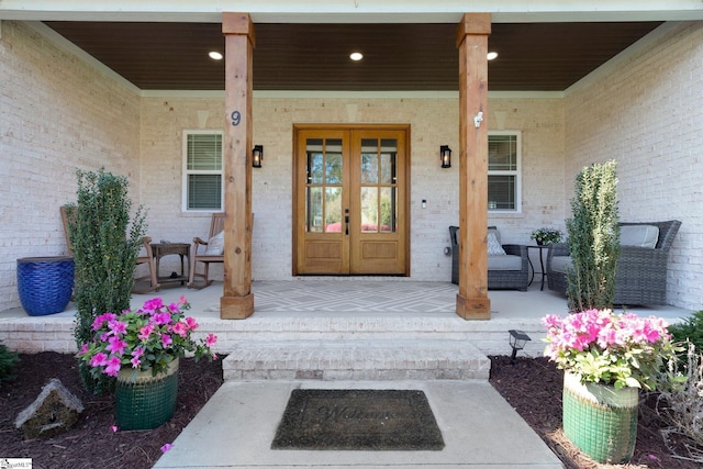 9 Graywood Ct, Simpsonville, SC 29680 - view of exterior entry featuring covered porch, french doors, and brick siding