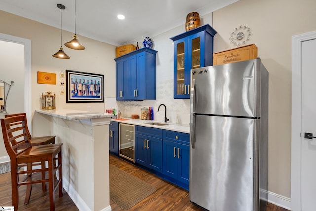 9 Graywood Ct, Simpsonville, SC 29680 - kitchen with wine cooler, a sink, blue cabinets, a kitchen breakfast bar, and freestanding refrigerator