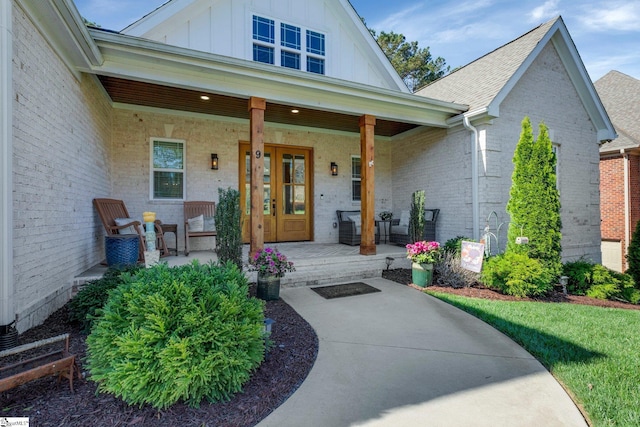 9 Graywood Ct, Simpsonville, SC 29680 - view of exterior entry featuring brick siding, a porch, and board and batten siding