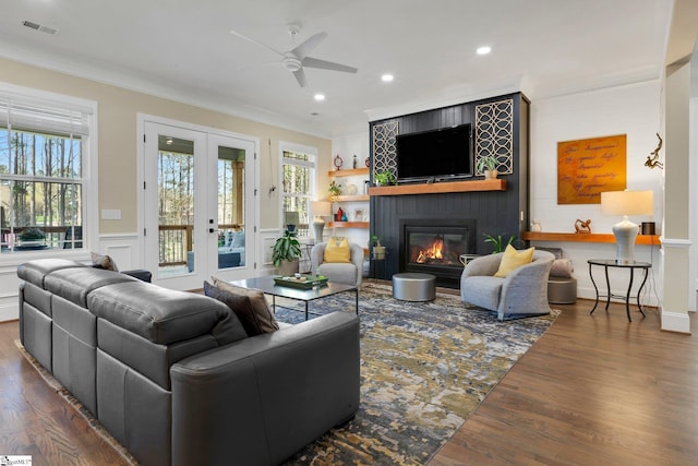 9 Graywood Ct, Simpsonville, SC 29680 - living room featuring ornamental molding, visible vents, a ceiling fan, a fireplace, and wood finished floors