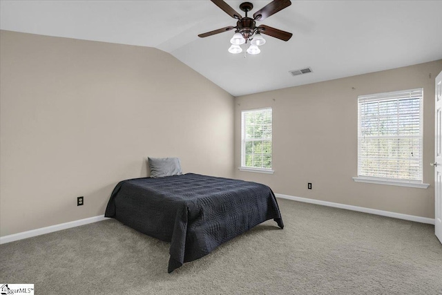 carpeted bedroom featuring a ceiling fan, baseboards, lofted ceiling, and visible vents