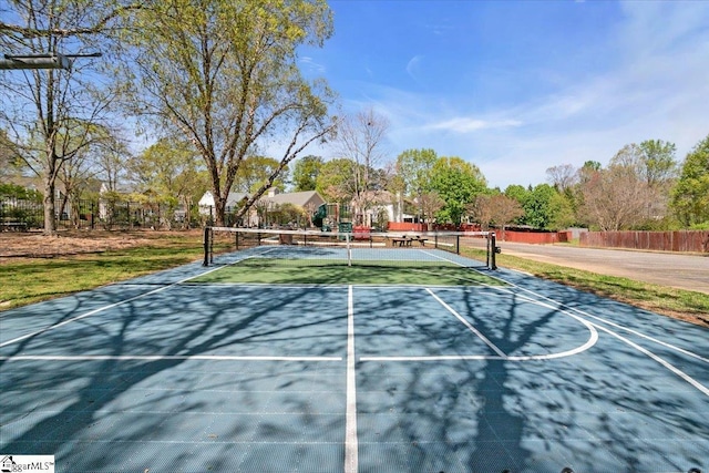 view of tennis court with fence