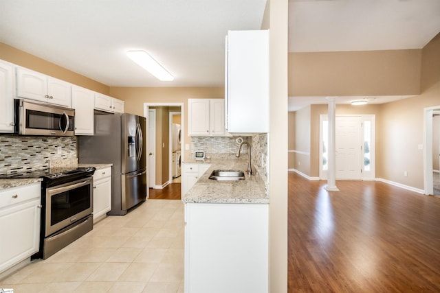 213 Lexington Place Way, Greenville, SC 29615 - kitchen with ornate columns, white cabinets, a sink, and stainless steel appliances