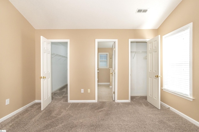 213 Lexington Place Way, Greenville, SC 29615 - unfurnished bedroom with visible vents, a closet, carpet, and a spacious closet