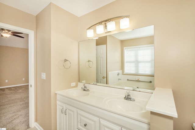 213 Lexington Place Way, Greenville, SC 29615 - bathroom featuring baseboards, double vanity, a sink, and a bath