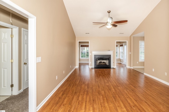 213 Lexington Place Way, Greenville, SC 29615 - unfurnished living room featuring vaulted ceiling, a fireplace with flush hearth, baseboards, light wood-style floors, and ceiling fan