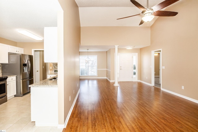 213 Lexington Place Way, Greenville, SC 29615 - kitchen with white cabinets, ceiling fan, light stone countertops, stainless steel appliances, and backsplash