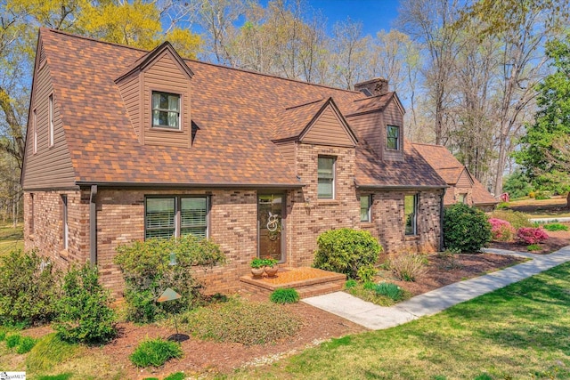 202 Mornington Ct, Simpsonville, SC 29681 - view of front of home featuring brick siding, a front yard, roof with shingles, and a chimney