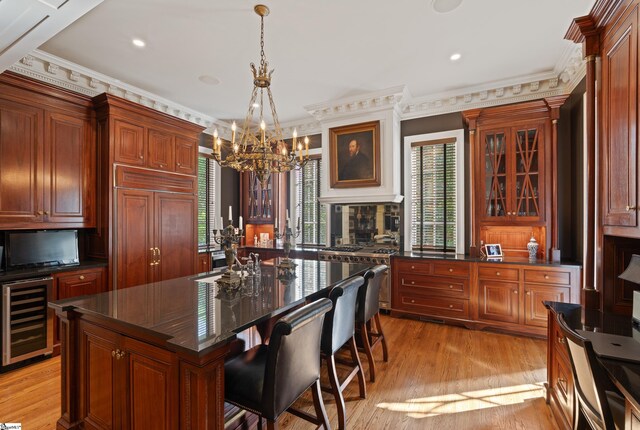 kitchen featuring a chandelier, wine cooler, glass insert cabinets, light wood-style floors, and built in fridge