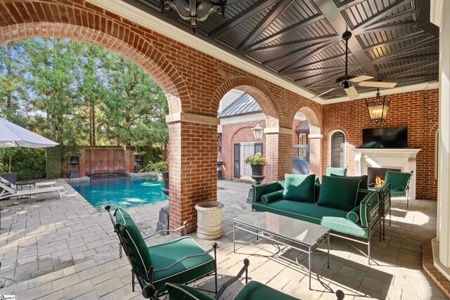 view of patio featuring a fenced backyard, an outdoor living space with a fireplace, a fenced in pool, and ceiling fan