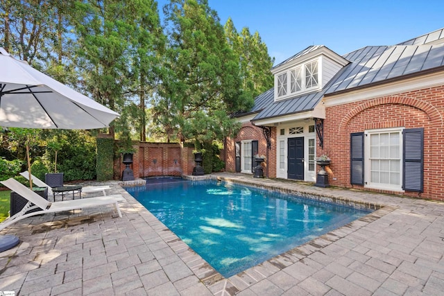 view of swimming pool with a fenced in pool, fence, and a patio