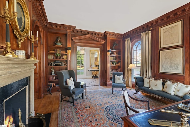 living room featuring a high end fireplace and wood finished floors