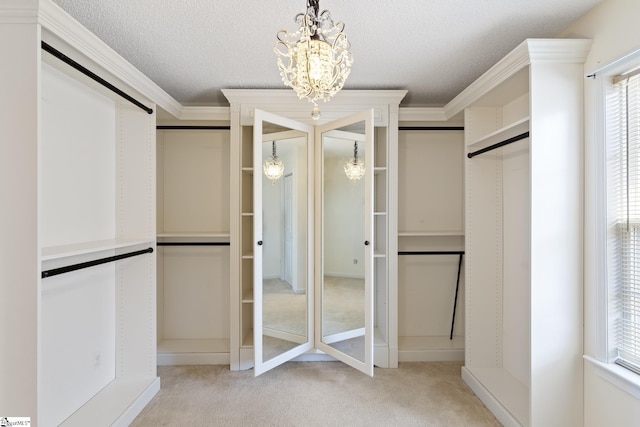 spacious closet featuring a notable chandelier and carpet floors