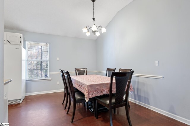 dining space featuring dark wood-style floors, vaulted ceiling, baseboards, and an inviting chandelier