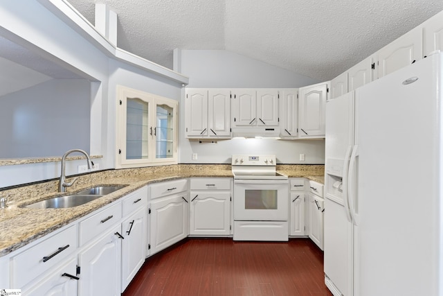 kitchen with lofted ceiling, white appliances, under cabinet range hood, a sink, and light stone countertops