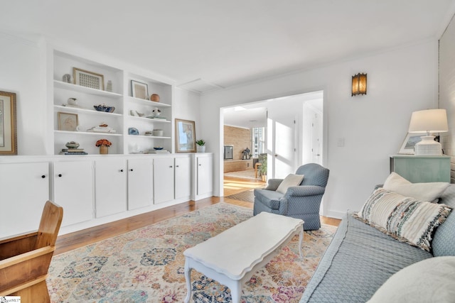 living room featuring light wood-style floors and built in features