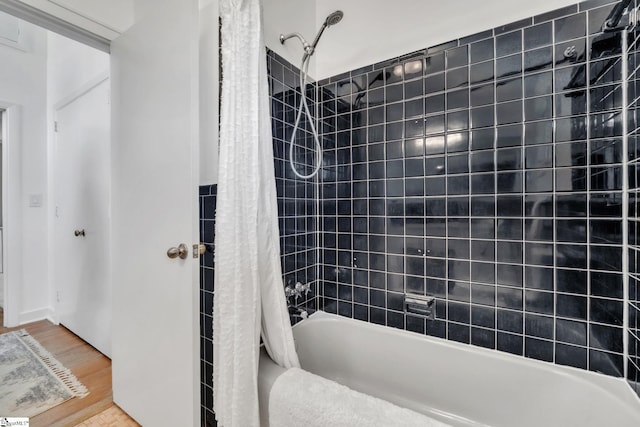 full bath featuring shower / bathtub combination with curtain and wood finished floors
