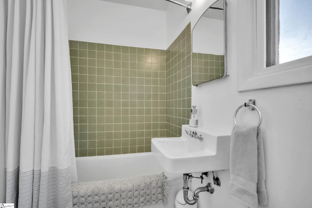 full bathroom with a sink and shower / tub combo with curtain