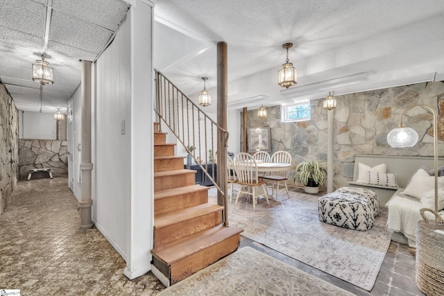 staircase featuring a textured ceiling