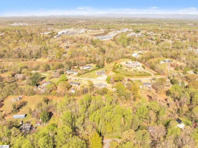 drone / aerial view with a wooded view