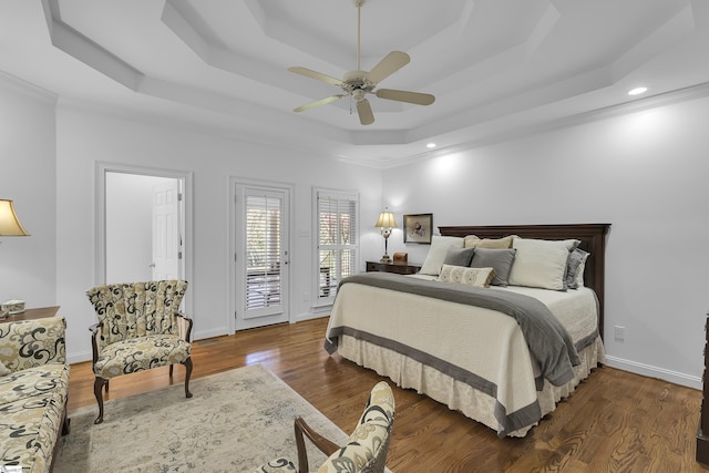 bedroom featuring a tray ceiling, baseboards, access to outside, ceiling fan, and wood finished floors