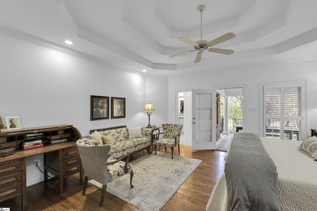 bedroom with wood finished floors, ceiling fan, recessed lighting, and a raised ceiling