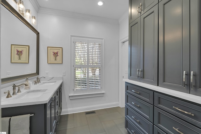 bathroom with double vanity, a sink, ornamental molding, and visible vents